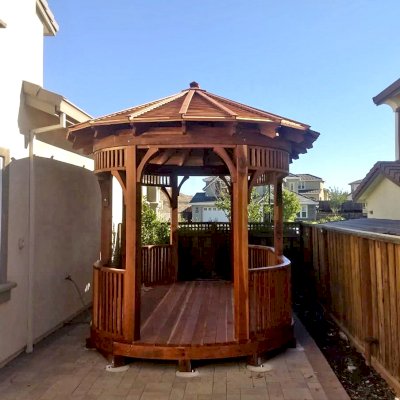 Custom Hexagonal Retreat Pavilion (Options: 15' L x 10'-6" W, Oval Shape Instead of Hexagonal by Custom Request, with Deck, California Redwood, With Upper Corvels and Lower Panels, Transparent Premium Sealant). Photo Courtesy of A. Singh of Dublin, California.
