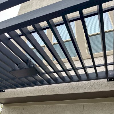 Custom Attached L.A. Modern Pergola (Options: 14' L, 7' W, Douglas-fir, No Rain Guard, 11.5 ft Post Height, 2 Electrical Wiring Trims, 2-Post Anchor Kit for Concrete, 1 Ceiling Fan Base, Black Stain Premium Sealant). Photo Courtesy of N. Nichols of Houston, Texas.