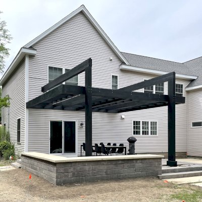 Custom Attached L.A. Modern Pergola (Options: 20' L, 16' W, Douglas-fir, 10 ft Post Height, 2 Electrical Wiring Trim Kits, 2-Post Anchor Kit for Concrete, No Ceiling Fan Base,  No Rain Guard, Black Stain Premium Sealant). Photo Courtesy of P. Ferland of Natick, Massachusetts.