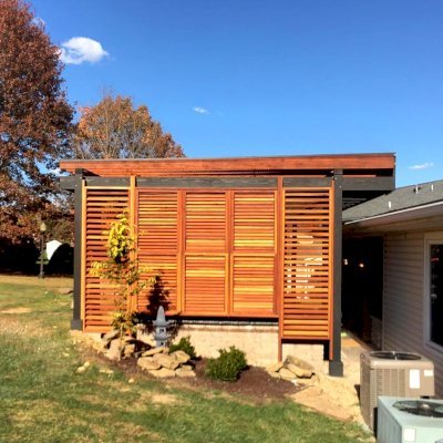 Custom L.A. Modern Pergola (Options: 42' L, 20' W, California Redwood, 10 ft Post Height, Electrical Wiring Trim for 1 Post, 8-Post Anchor Kit for Concrete, 1 Ceiling Fan Base, Rain Guard [3/16" Polycarbonate], Transparent Premium Sealant for Louvers & Rafters and Black Stain for Posts & Supports). Photo Courtesy of L &M Oliverio of Bridgeport, West Virginia.