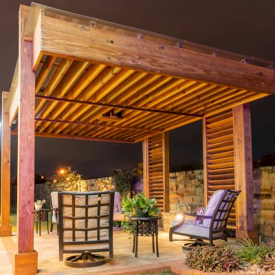 L.A. Modern Pergola (Options: 16' L, 12' W, California Redwood, with Rain Guard, 10 ft Post Height, 2 Electrical Wiring Trims, 4-Post Anchor Kit for Concrete, 1 Ceiling Fan Base, No Retractable Shade Canopy, Transparent Premium Sealant). Photo Taken 1 Year After Installation. Photo Courtesy of T. Huber of Round Rock, TX.