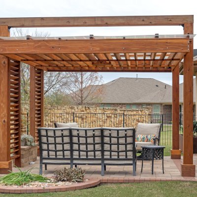L.A. Modern Pergola (Options: 16' L, 12' W, California Redwood, with Rain Guard, 10 ft Post Height, 2 Electrical Wiring Trims, 4-Post Anchor Kit for Concrete, 1 Ceiling Fan Base, No Retractable Shade Canopy, Transparent Premium Sealant). Photo Taken 1 Year After Installation. Photo Courtesy of T. Huber of Round Rock, TX.