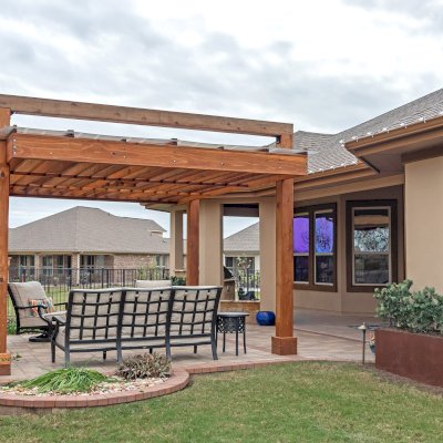 L.A. Modern Pergola (Options: 16' L, 12' W, California Redwood, with Rain Guard, 10 ft Post Height, 2 Electrical Wiring Trims, 4-Post Anchor Kit for Concrete, 1 Ceiling Fan Base, No Retractable Shade Canopy, Transparent Premium Sealant). Photo Taken 1 Year After Installation. Photo Courtesy of T. Huber of Round Rock, TX.