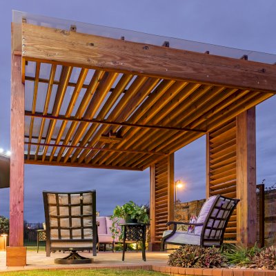 L.A. Modern Pergola (Options: 16' L, 12' W, California Redwood, with Rain Guard, 10 ft Post Height, 2 Electrical Wiring Trims, 4-Post Anchor Kit for Concrete, 1 Ceiling Fan Base, No Retractable Shade Canopy, Transparent Premium Sealant). Photo Taken 1 Year After Installation. Photo Courtesy of T. Huber of Round Rock, TX.