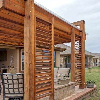 L.A. Modern Pergola (Options: 16' L, 12' W, California Redwood, with Rain Guard, 10 ft Post Height, 2 Electrical Wiring Trims, 4-Post Anchor Kit for Concrete, 1 Ceiling Fan Base, No Retractable Shade Canopy, Transparent Premium Sealant). Photo Taken 1 Year After Installation. Photo Courtesy of T. Huber of Round Rock, TX.