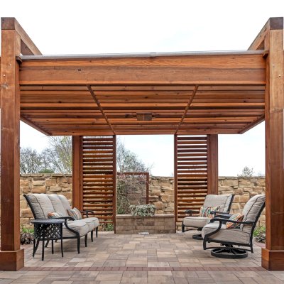 L.A. Modern Pergola (Options: 16' L, 12' W, California Redwood, with Rain Guard, 10 ft Post Height, 2 Electrical Wiring Trims, 4-Post Anchor Kit for Concrete, 1 Ceiling Fan Base, No Retractable Shade Canopy, Transparent Premium Sealant). Photo Taken 1 Year After Installation. Photo Courtesy of T. Huber of Round Rock, TX.