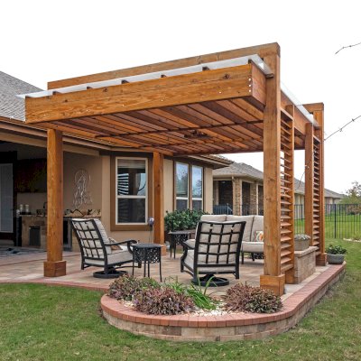 L.A. Modern Pergola (Options: 16' L, 12' W, California Redwood, with Rain Guard, 10 ft Post Height, 2 Electrical Wiring Trims, 4-Post Anchor Kit for Concrete, 1 Ceiling Fan Base, No Retractable Shade Canopy, Transparent Premium Sealant). Photo Taken 1 Year After Installation. Photo Courtesy of T. Huber of Round Rock, TX.