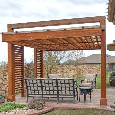 L.A. Modern Pergola (Options: 16' L, 12' W, California Redwood, with Rain Guard, 10 ft Post Height, 2 Electrical Wiring Trims, 4-Post Anchor Kit for Concrete, 1 Ceiling Fan Base, No Retractable Shade Canopy, Transparent Premium Sealant). Photo Taken 1 Year After Installation. Photo Courtesy of T. Huber of Round Rock, TX.