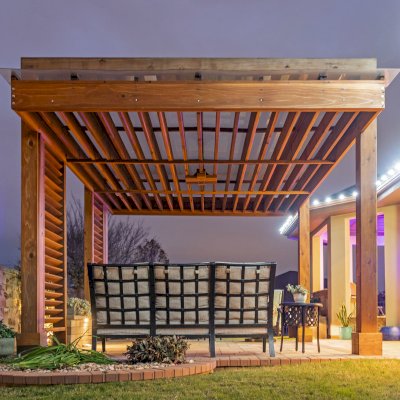 L.A. Modern Pergola (Options: 16' L, 12' W, California Redwood, with Rain Guard, 10 ft Post Height, 2 Electrical Wiring Trims, 4-Post Anchor Kit for Concrete, 1 Ceiling Fan Base, No Retractable Shade Canopy, Transparent Premium Sealant). Photo Taken 1 Year After Installation. Photo Courtesy of T. Huber of Round Rock, TX.