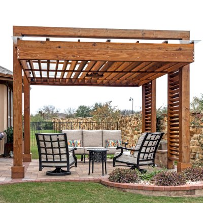L.A. Modern Pergola (Options: 16' L, 12' W, California Redwood, with Rain Guard, 10 ft Post Height, 2 Electrical Wiring Trims, 4-Post Anchor Kit for Concrete, 1 Ceiling Fan Base, No Retractable Shade Canopy, Transparent Premium Sealant). Photo Taken 1 Year After Installation. Photo Courtesy of T. Huber of Round Rock, TX.