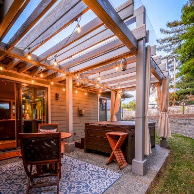 Custom L.A. Modern Pergola (Options: 17' L, 12' W, Douglas-fir, 10.5 ft Post Height, No Electrical Wiring Trim Kit, 4-Post Anchor Kit for Concrete, No Ceiling Fan Base,  with Transparent Rain Guard, Custom Paint Finish) with 1 Standalone Privacy Panel (Louvered). Photo Courtesy of J. Williamson of Bow, Washington.