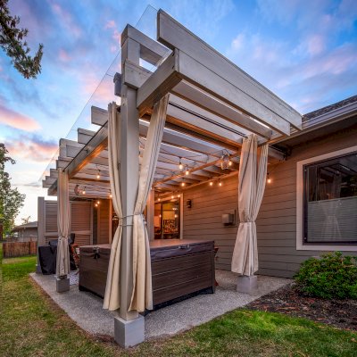 Custom L.A. Modern Pergola (Options: 17' L, 12' W, Douglas-fir, 10.5 ft Post Height, No Electrical Wiring Trim Kit, 4-Post Anchor Kit for Concrete, No Ceiling Fan Base,  with Transparent Rain Guard, Custom Paint Finish) with 1 Standalone Privacy Panel (Louvered). Photo Courtesy of J. Williamson of Bow, Washington.