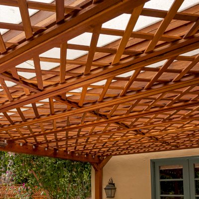 Custom Lattice Pergola Kit (Options: 19' L x 16' W, California Redwood, Electrical Wiring Trim for 2 Posts, 4-Post Kit for Concrete, No Ceiling Fan Base, No Privacy Panels, No Curtain Rods, 9' Post Height, Transparent Premium Sealant). Lattice panels were customized with larger openings than is the standard design. Photo Courtesy of D. Wood of Palo Alto, California.