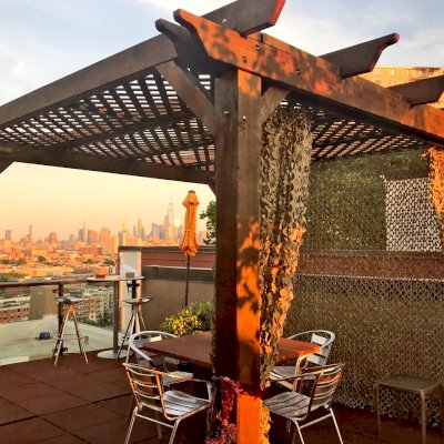 Add Some Fabric For a Special Touch. Lattice Pergola Kit (Options: 10' x 10', Mature Redwood, No Electrical Wiring Trim, 4-Post Anchor Kit for Concrete, No Ceiling Fan Base, No Privacy Panels, No Curtain Rods, 9' Post Height, Transparent Premium Sealant). Photo Courtesy of Fabienne Jacquet of Union City, New Jersey.