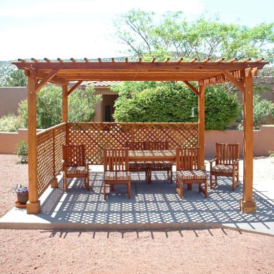 Lattice Pergola Kit (Options: 15' x 15', California Redwood, No Electrical Wiring Trim, 4-post Anchor Kit for Concrete, No Ceiling Fan Base, 2 Privacy Panels, No Curtain Rods, 9' Post Height, Transparent Premium Sealant). 2x2 Slats Above Rafters was Added as Custom Detail. It is not Part of Standard Design. Under the Pergola, a 7' San Francisco Patio Table Set with 42" W Tabletop, 4 Ruth Chairs and 2 Ruth Armchairs. Photo Courtesy of Mr. Joseph Dlugosz of Sedona, AZ.