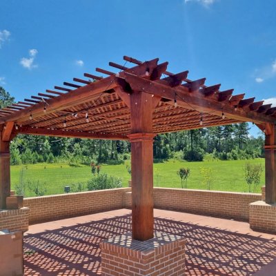 Custom Lattice Pergola Kit (Options: 20' L x 20' W, California Redwood, No Electrical Wiring Trim, Lengthwise Roof Support Timbers, 4-Post Anchor Kit for High-Wind, No ceiling Fan Base, No Privacy Panels, Horizontal Post Decorative Trims, 9.5' Post Height, Transparent Premium Sealant). 2x2 Slats Above Rafters Added by Custom Request. Customer envloved the lower part of the posts with masonry.