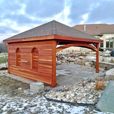 Loreto Pavilion (Options: 20' L x 20' W, 8x8 Posts, No Privacy Panels, California Redwood, 10' H, Electrical Wiring Trim for 1 Post, 4-Post Anchor Kit for High-Wind, No Post Decorative Trim, 1 Ceiling Fan Base, No Curtain Rods, Transparent Premium Sealant, Custom Wall with Shutters). Photo Courtesy of A. Schurman of Cedar Falls, Iowa.
