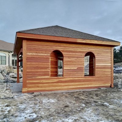 Loreto Pavilion (Options: 20' L x 20' W, 8x8 Posts, No Privacy Panels, California Redwood, 10' H, Electrical Wiring Trim for 1 Post, 4-Post Anchor Kit for High-Wind, No Post Decorative Trim, 1 Ceiling Fan Base, No Curtain Rods, Transparent Premium Sealant, Custom Wall with Shutters). Photo Courtesy of A. Schurman of Cedar Falls, Iowa.