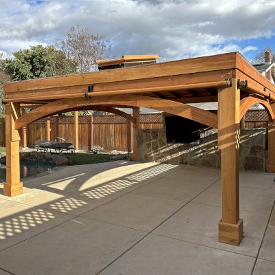 Custom Loreto Pavilion (Options: 16' L x 16' W, 8x8 Posts, No Privacy Panels, Douglas-fir, 7.5' H Posts, with 1 Skylight, 12:3 Roof Pitch Instead the Standard 12:7, 1 Electrical Wiring Trim, 4-Post Anchor Kit for High Wind, No Post Decorative Trims, 1 Ceiling Fan Base, with 3 Curtain Rods, Transparent Premium Sealant). Photo Courtesy of C. Ashley of Pleasanton, CA.