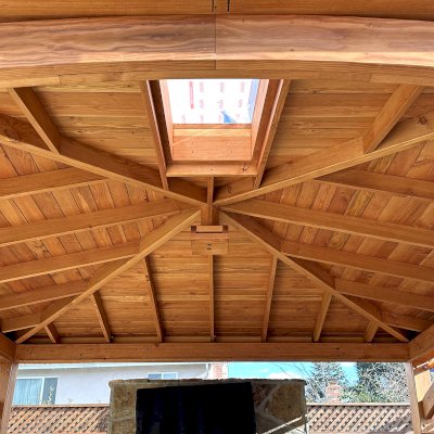 Custom Loreto Pavilion (Options: 16' L x 16' W, 8x8 Posts, No Privacy Panels, Douglas-fir, 7.5' H Posts, with 1 Skylight, 12:3 Roof Pitch Instead the Standard 12:7, 1 Electrical Wiring Trim, 4-Post Anchor Kit for High Wind, No Post Decorative Trims, 1 Ceiling Fan Base, with 3 Curtain Rods, Transparent Premium Sealant). Photo Courtesy of C. Ashley of Pleasanton, CA.