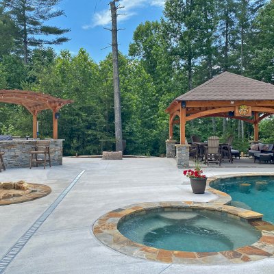 Loreto Pavilion (Options: 20' L x 20' W, 8x8 Posts, No Privacy Panels, Douglas-fir, 9.5' H, Electrical Wiring for 1 Post, 4-Post Anchor Kit for High Wind, No Post Decorative Trim, 1 Ceiling Fan Base, No Curtain Rods, Transparent Premium Sealant). Photo Also Shows a Marin Pergola. Photo Courtesy of Bill & Lori O’Mara of Marion, North Carolina.