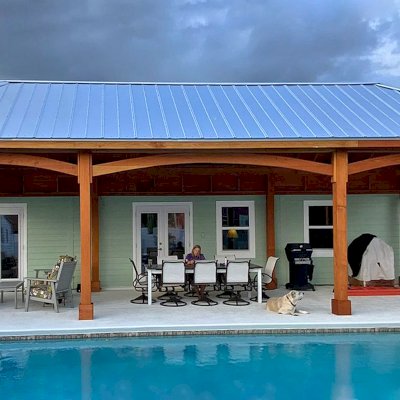 Loreto Pavilion (Options: 44' L x 16' W, 8x8 Posts, No Privacy Panels, Douglas-fir, 10' H, Electrical Wiring for 4 Posts, 8-Post Anchor Kit for High-Wind, No Post Decorative Trim, 3 Ceiling Fan Bases, with Fascia Boards for Gutters, Transparent Premium Sealant). Photo Courtesy of T. Lentz of Port St. Lucie, FL.