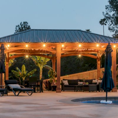 Loreto Pavilion (Options: 26' L x 14' W, 8x8 Posts, No Privacy Panels, California Redwood, 9.5' H, Electrical Wiring for 3 Posts, 6-Post Anchor Kit for High-Wind, No Post Decorative Trim, 2 Ceiling Fan Bases, Transparent Premium Sealant). Photo Courtesy of M. Holmes of Lakeside, CA.