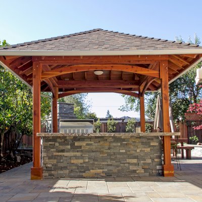 Loreto Pavilion (Options: 14' x 14', 6x6 Posts, California Redwood, 4-Post Anchor Kit for High-Wind, 1 Electrical Wiring Trim Kit, 2ft Overhangs by Custom Request, Transparent Premium Sealant). Gutters added by Forever Redwood install team and can be added to any pavilion by request. Photo Courtesy of B. Hirschbeck of Los Altos, CA.