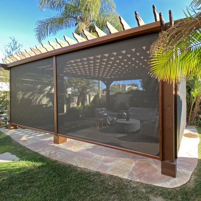 Custom Montvale Pergola (Options: Irregular Shape That is 14' x 16' on 2 Adjacent Sides, But the Side Opposite the 16' was Extended to 22' and Have a 5th Post, California Redwood, 9.5' Posts, Coffee-Stain Premium Sealant). Customer Added Retractable Shade as a Privacy Panel. Photo Courtesy of G. Tanaka of Torrance, CA.