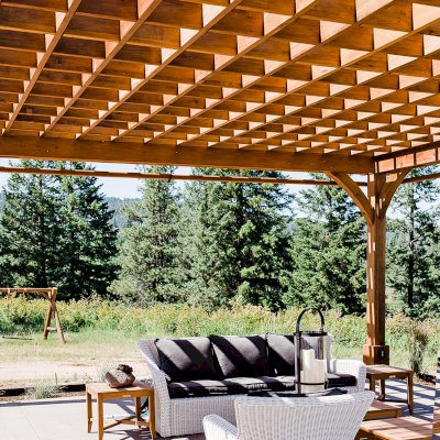 Montvale Pergolas  (Options: 22' x 22', Mature Redwood, 4-Post Anchor Kit for Concrete, Electrical Wiring Trim Kit for 4 Posts, No Ceiling Fan Base, 4 Curtain Rods, No Privacy Panels, 10' Post, Transparent Premium Sealant). Photo Courtesy of J. Scott of Coeur deline, Idaho.