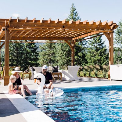 Montvale Pergolas  (Options: 22' x 22', Mature Redwood, 4-Post Anchor Kit for Concrete, Electrical Wiring Trim Kit for 4 Posts, No Ceiling Fan Base, 4 Curtain Rods, No Privacy Panels, 10' Post, Transparent Premium Sealant). Photo Courtesy of J. Scott of Coeur deline, Idaho.
