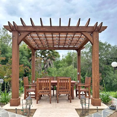 Montvale Pergola (Options: 12' x 12', California Redwood, 4-Post Anchor Kit for Concrete, No Ceiling Fan Base, No Curtain Rods, No Privacy Panels, 9.5' H Posts, Coffee-Stain Premium Sealant). Photo Also Shows a San Francisco Patio Table Set with Ruth Chairs. Photo Courtesy of M. Dopudja of Fallbrook, CA.