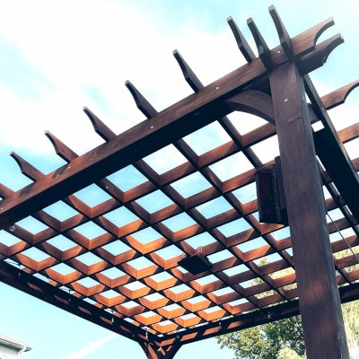Montvale Pergolas (Options: 16' x 16', Douglas-fir, 10 ft H, 1 Ceiling Fan Base, No Post Decorative Trims, Coffee-Stain Premium Sealant). Photo Courtesy of Billy & Brianne Foster of Olathe, KS.
