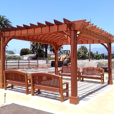 Montvale Pergolas (Options: 16' x 20', Mature Redwood, 4-Post Anchor Kit for Concrete, No Ceiling Fan Base, No Curtain Rods, No Privacy Panels, 9.5' Post, Transparent Premium Sealant). Photo also shows 4 Luna Memorial Benches. Photos taken in Carpinteria Garden Park during construction, May 10, 2017. Photo Courtesy of Carpinteria Park, 5775 Carpinteria Avenue  Carpinteria, CA  93013.