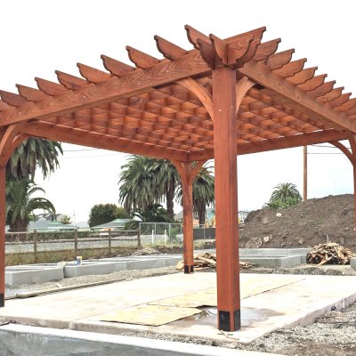 Montvale Pergolas (Options: 16' x 20', Mature Redwood, 4-Post Anchor Kit for Concrete, No Ceiling Fan Base, No Curtain Rods, No Privacy Panels, 9.5' Post, Transparent Premium Sealant). Photos taken in Carpinteria Garden Park during construction, May 10, 2017. Photo Courtesy of Carpinteria Park, 5775 Carpinteria Avenue  Carpinteria, CA  93013.