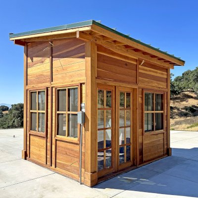 Palo Alto Backyard Cabin (Options: 10' L, 12' W, Without Porch, California Redwood for Exterior Finished, Douglas-fir Internal Walls and Framing, With 2 French Doors, Slidding Windows, Windows Purchased Locally, With 4' x 4' Skylight, Metal Roof, Electrical Wire Trim on the Walls, Transparent Premium Sealant). Photo Courtesy of M. Diaz of Fairfield, CA.