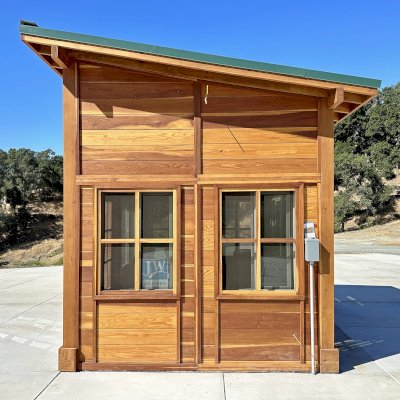 Palo Alto Backyard Cabin (Options: 10' L, 12' W, Without Porch, California Redwood for Exterior Finished, Douglas-fir Internal Walls and Framing, With 2 French Doors, Slidding Windows, Windows Purchased Locally, With 4' x 4' Skylight, Metal Roof, Electrical Wire Trim on the Walls, Transparent Premium Sealant). Photo Courtesy of M. Diaz of Fairfield, CA.