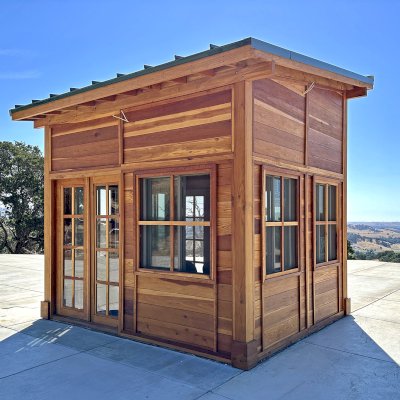 Palo Alto Backyard Cabin (Options: 10' L, 12' W, Without Porch, California Redwood for Exterior Finished, Douglas-fir Internal Walls and Framing, With 2 French Doors, Slidding Windows, Windows Purchased Locally, With 4' x 4' Skylight, Metal Roof, Electrical Wire Trim on the Walls, Transparent Premium Sealant). Photo Courtesy of M. Diaz of Fairfield, CA.