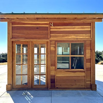 Palo Alto Backyard Cabin (Options: 10' L, 12' W, Without Porch, California Redwood for Exterior Finished, Douglas-fir Internal Walls and Framing, With 2 French Doors, Slidding Windows, Windows Purchased Locally, With 4' x 4' Skylight, Metal Roof, Electrical Wire Trim on the Walls, Transparent Premium Sealant). Photo Courtesy of M. Diaz of Fairfield, CA.