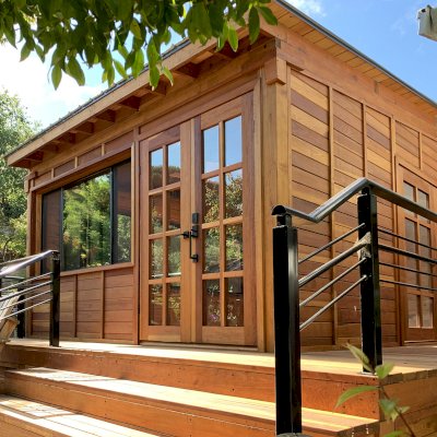 Palo Alto Backyard Cabin (Options: 18' L, 16' W, Without Porch, Structural Deck - Interior and 4' Exterior, California Redwood, Sugar Pine Internal Walls and Ceiling, Windows Purchased Locally, With Two 3' x 5' Skylights, Metal Roof, Custom Railings and Steps, Electrical Wire Trim on the Walls, Transparent Premium Sealant). Photo Courtesy of A. Ramon of South San Francisco, California.
