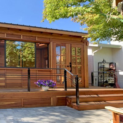 Palo Alto Backyard Cabin (Options: 18' L, 16' W, Without Porch, Structural Deck - Interior and 4' Exterior, California Redwood, Sugar Pine Internal Walls and Ceiling, Windows Purchased Locally, With Two 3' x 5' Skylights, Metal Roof, Custom Railings and Steps, Electrical Wire Trim on the Walls, Transparent Premium Sealant). Photo Courtesy of A. Ramon of South San Francisco, California.