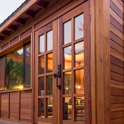 Palo Alto Backyard Cabin (Options: 18' L, 16' W, Without Porch, Structural Deck - Interior and 4' Exterior, California Redwood, Sugar Pine Internal Walls and Ceiling, Windows Purchased Locally, With Two 3' x 5' Skylights, Metal Roof, Custom Railings and Steps, Electrical Wire Trim on the Walls, Transparent Premium Sealant). Photo Courtesy of A. Ramon of South San Francisco, California.