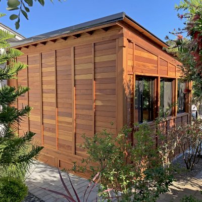 Palo Alto Backyard Cabin (Options: 18' L, 16' W, Without Porch, Structural Deck - Interior and 4' Exterior, California Redwood, Sugar Pine Internal Walls and Ceiling, Windows Purchased Locally, With Two 3' x 5' Skylights, Metal Roof, Custom Railings and Steps, Electrical Wire Trim on the Walls, Transparent Premium Sealant). Photo Courtesy of A. Ramon of South San Francisco, California.