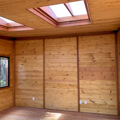 Palo Alto Backyard Cabin (Options: 18' L, 16' W, Without Porch, Structural Deck - Interior and 4' Exterior, California Redwood, Sugar Pine Internal Walls and Ceiling, Windows Purchased Locally, With Two 3' x 5' Skylights, Metal Roof, Custom Railings and Steps, Electrical Wire Trim on the Walls, Transparent Premium Sealant). Photo Courtesy of A. Ramon of South San Francisco, California.