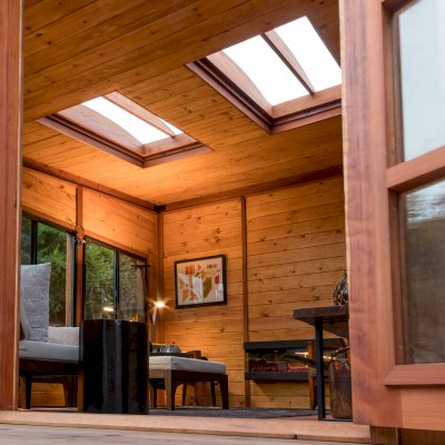 Palo Alto Backyard Cabin (Options: 18' L, 16' W, Without Porch, Structural Deck - Interior and 4' Exterior, California Redwood, Sugar Pine Internal Walls and Ceiling, Windows Purchased Locally, With Two 3' x 5' Skylights, Metal Roof, Custom Railings and Steps, Electrical Wire Trim on the Walls, Transparent Premium Sealant). Photo Courtesy of A. Ramon of South San Francisco, California.