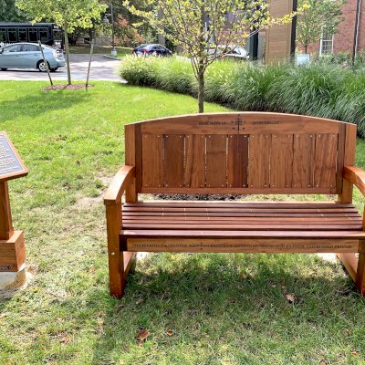 Presidential Bench (Options: 5 ft, No Cushion, Custom Engraving). Bench installed in Adelaide of Newton Centre in 157 Herrick Road, Newton, MA 02459.