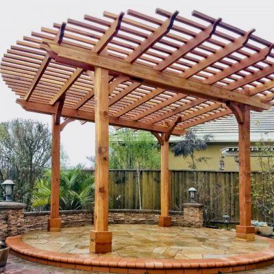 Round Pergola (Options: 16' Diameter, No Privacy Panel, California Redwood, Open Roof Slats at 6", 9.5ft Post Height, Include Electrical Wiring Trim for 2 Posts, 4-Post Anchor Kit for Stone, No Post Decorative Trim, No Ceiling Fan Base, No Curtain Rods, Transparent Premium Sealant). Photo courtesy of Harish B. of Dublin, CA
