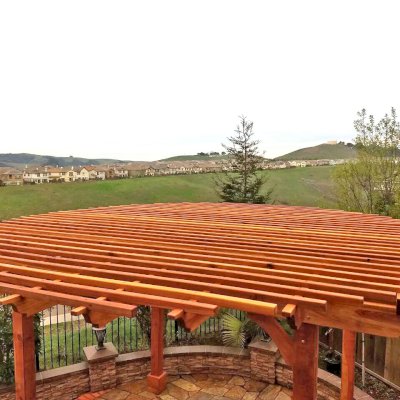 Round Pergola (Options: 16' Diameter, No Privacy Panel, California Redwood, Open Roof Slats at 6", 9.5ft Post Height, Include Electrical Wiring Trim for 2 Posts, 4-Post Anchor Kit for Stone, No Post Decorative Trim, No Ceiling Fan Base, No Curtain Rods, Transparent Premium Sealant). Photo courtesy of Harish B. of Dublin, CA