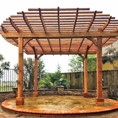Round Pergola (Options: 16' Diameter, No Privacy Panel, California Redwood, Open Roof Slats at 6", 9.5ft Post Height, Include Electrical Wiring Trim for 2 Posts, 4-Post Anchor Kit for Stone, No Post Decorative Trim, No Ceiling Fan Base, No Curtain Rods, Transparent Premium Sealant). Photo courtesy of Harish B. of Dublin, CA