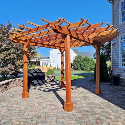 Round Pergola (Options: 16' Diameter, No Privacy Panel, California Redwood, Open Roof Slats at 18", 9ft Post Height, Include Electrical Wiring Trim for 2 Posts, 4-Post Anchor Kit for Concrete, No Post Decorative Trim, 1 Ceiling Fan Base, No Curtain Rods, Transparent Premium Sealant). Photo courtesy of J. Holobinko of Hagerstown, MD.